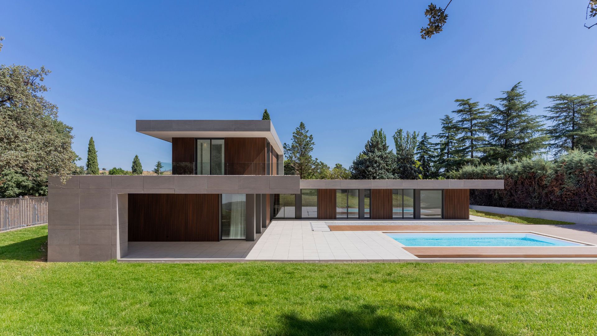 Fachada casa en L en Madrid con esquina y piscina